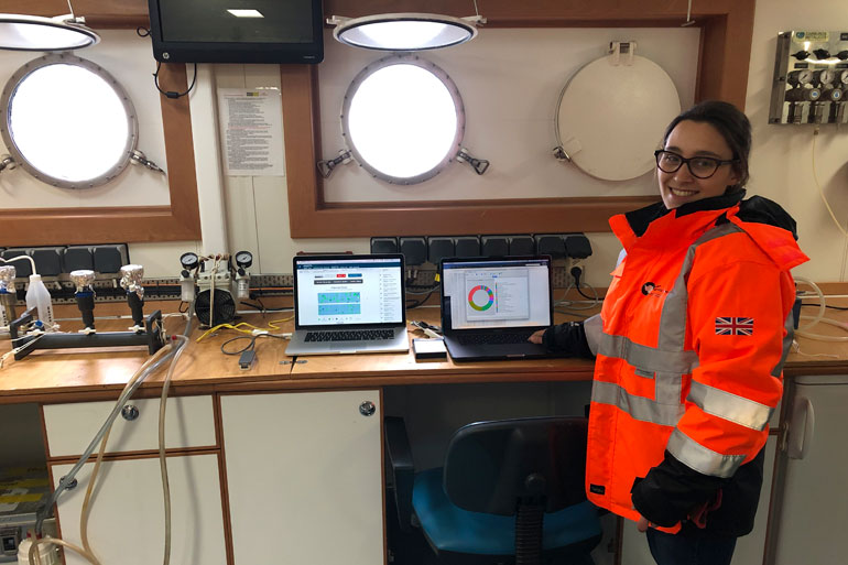 Emma setting up laptops and Nanopore MinION DNA sequencing equipment in lab onboard RRS Discovery ship Emma setting up laptops and Nanopore MinION DNA sequencing equipment in lab onboard RRS Discovery ship