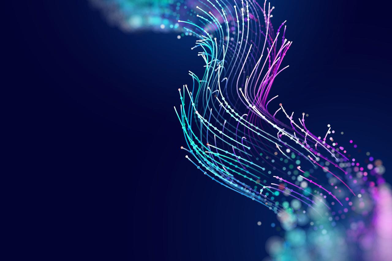 Abstract computational image of multicoloured lines in a wave in shades of light blue and pink against a dark blue background.