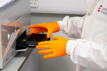 Scientists with sequencing samples in the lab