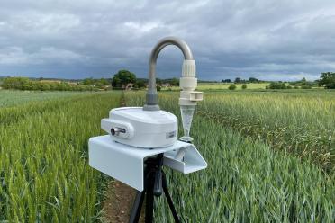 AirSeq machinery placed in a field of young wheat, with a grey, stormy backdrop.
