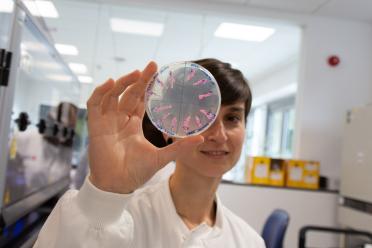 Researcher Eleonora holding up a petri dish close to the camera