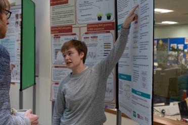 PhD student Lucy presenting her research poster at the last Earlham Student Symposium
