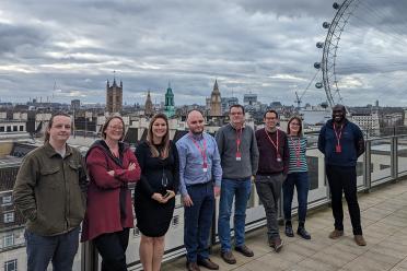 The project team photographed with the London skyline behind them.