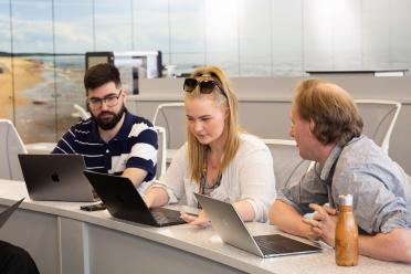 Colleagues at a desk during a meeting