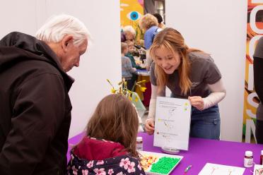 Stella volunteering at the "Making medicines from plants" stand at the Norwich Science Festival