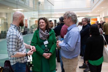 Staff from EI chatting during an event networking