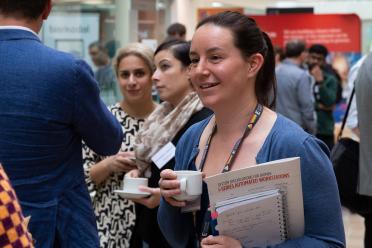 Ashleigh Lister speaking with a colleague during a seminar networking break
