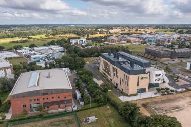 Aerial view of the Norwich Research Park, showing the location of the Earlham Institute, Quadram Institute, and Norfolk and Norwich University Hospital