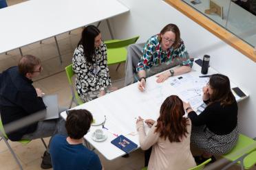 Colleagues gathered around a table
