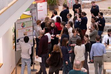 PhD and Year in Industry students networking during a poster presentation break at an EI conference