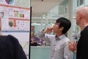 Jhih-Sheng discussing his research poster at a recent EI symposium