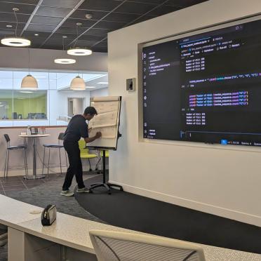 Gurpinder leads a training session on coding