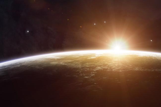 Sunburst over the horizon of earth from space