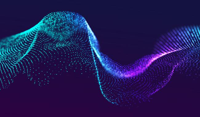 Abstract wave made up of particles in shades of turquoise, blue and purple